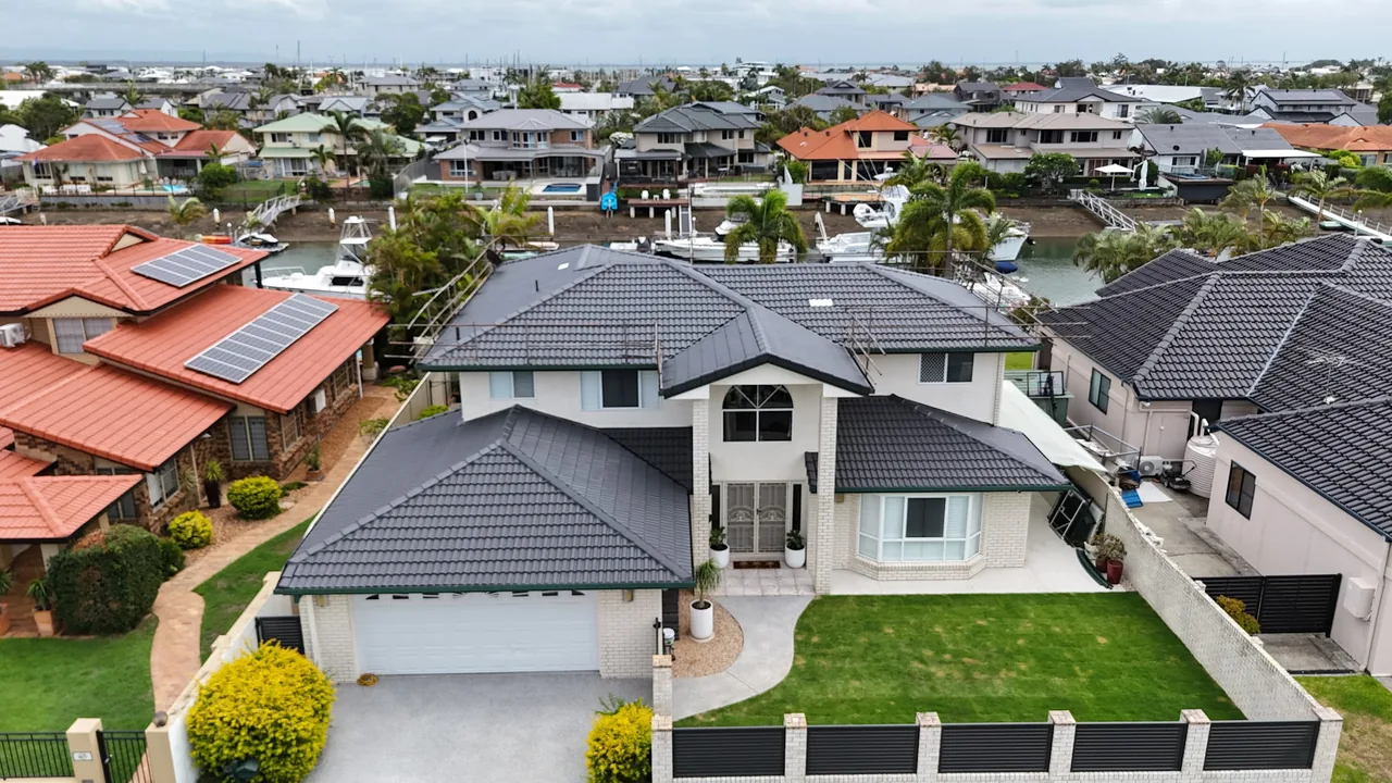 Freshly recoated charcoal tile roof on a two-storey Brisbane waterfront home
